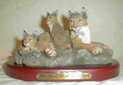 Figurine featuring a Bobcat mother and two cubs